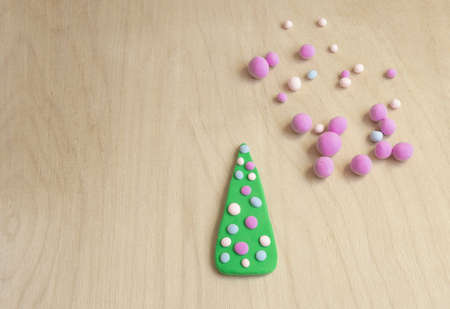 creative christmas tree 2022 made of plasticine on a wooden background, christmas conceptの写真素材