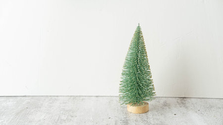 a small green Christmas tree figurine Christmas 2022