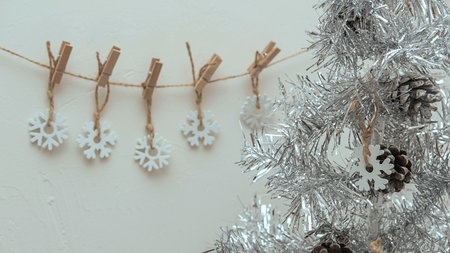 white snowflakes suspended on a clothespin Christmas 2022の写真素材