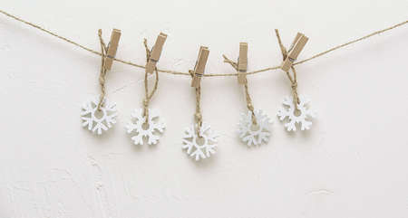 white snowflakes suspended on a clothespin Christmasの写真素材