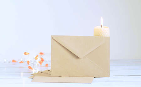 a letter made of crane paper on the background of a burning candleの写真素材