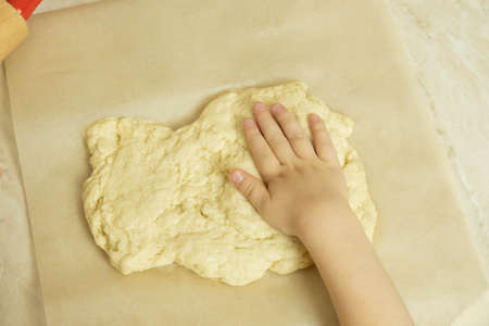 the process of making pizza dough by a childの写真素材