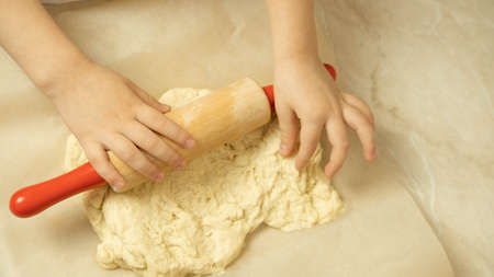 the process of making pizza dough by a childの写真素材