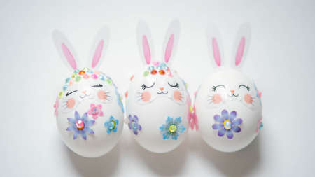 banner. Easter eggs in the form of hares on a white background. Flat styling. Copy the place for the text.の写真素材