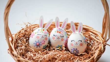 banner. Easter eggs in the form of hares on a white background. Flat styling. Copy the place for the text.の写真素材
