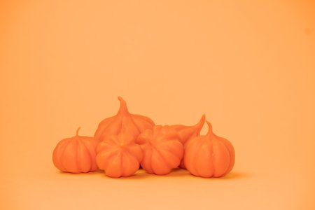 Halloween concept, orange pumpkin on an orange background with a place for text