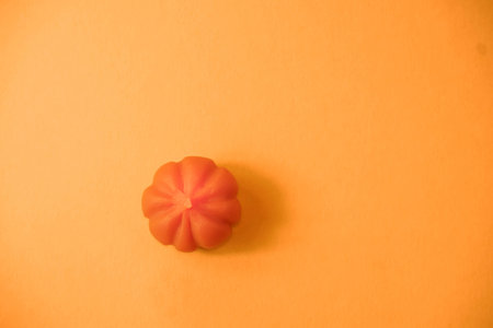 Halloween concept, orange pumpkin on an orange background with a place for text