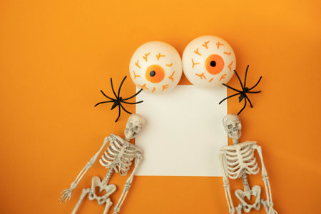 toy eyes on an orange background with a place for text, halloween conceptの写真素材