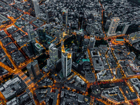 Aerial Overhead View of Frankfurt am Main, Germany Skyline at Night with glowing Streets, Circa...