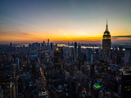 High rise buildings in arranged in blocks surrounded with streets. Cityscape against colourful...