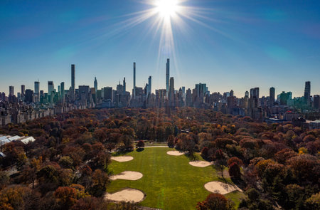 Wide panoramic aerial shot of autumn in Central Park and surrounding high rise buildings against...