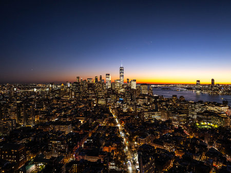 Stunning aerial view of New York City skyline at sunset with one world trade center in the Financial...