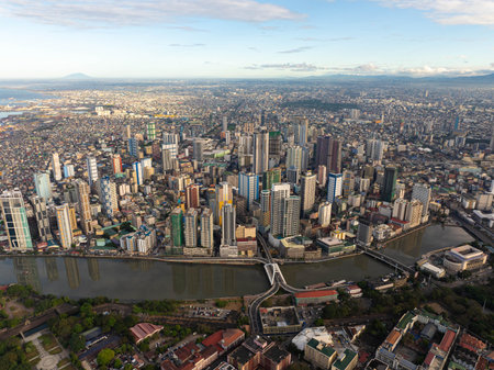 Aerial view of Manila, Philippines, showcasing modern skyscrapers and crowded residential areas...
