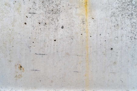 Aged concrete with yellow patterns and cracks - high quality texture / backgroundの写真素材