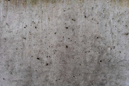 Aged concrete with holes, patterns and cracks - high quality texture / backgroundの写真素材