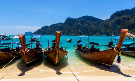 Long-tail boats on sandy beach, Phi Phi Don islandの写真素材