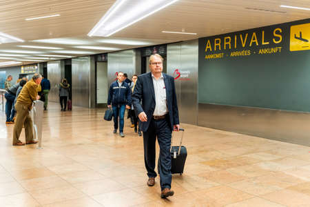 Brussels, Belgium, May 2019 Brussels airport, people waiting and going to meet their friends and families, arrivals hallのeditorial素材