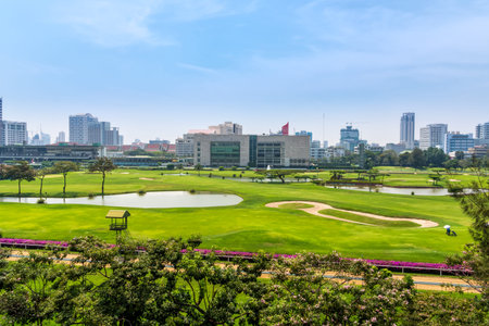 Golf course in hart of Bangkok, city skyline in the backgroundの写真素材
