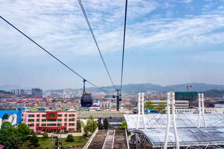 Cable cart on the way back to the city, cityscape with cloudy skyのeditorial素材