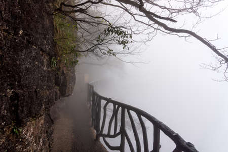 Sky walk at Tianmen Mountain vanishing in very heavy mist, fog or inverted cloud Zhangjiajie, Hunan, Chinaの写真素材