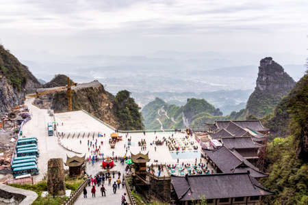 Zhangjiajie, Hunan, China Apr 2013 Crowd of tourists visiting Haven Gate in Tianman Mountain. High view from stairs on valley and facilities below.のeditorial素材