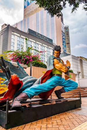 Hong Kong, China, March 2013 Statues of famous characters, in Hong Kong Avenue of Comic Stars, Kowloon Park. Urban skyline background of Tsim Sha Tsui Districtのeditorial素材