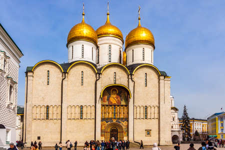 Moscow, Russia, April 2013 Tourists visiting Dormition Cathedral with majestic golden copulas or domes in Kremlinのeditorial素材
