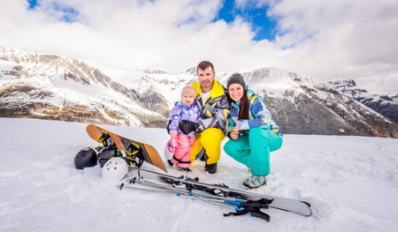 Happy family, male, female and child on ski and snowboard holidays, snow and winter in mountains, family time and happiness, safety Livigno Italy Alpsの写真素材