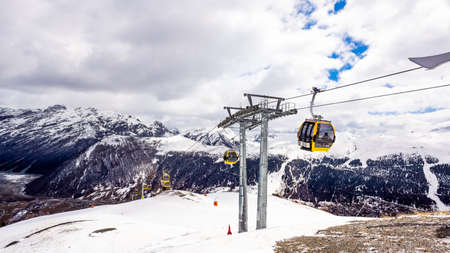 Beautiful mountains in winter, slopes and pistes with ski lifts, ski and snowboard holidays, Livigno village, Italy, Alpsの写真素材