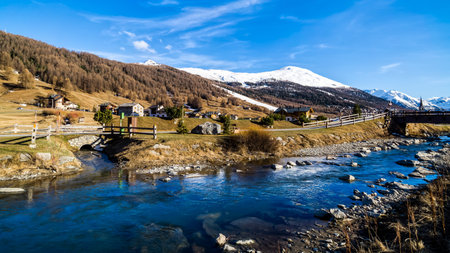 Beautiful mountain valley with stream and bridges, trees, wooden fence and footpath, Livingo village...