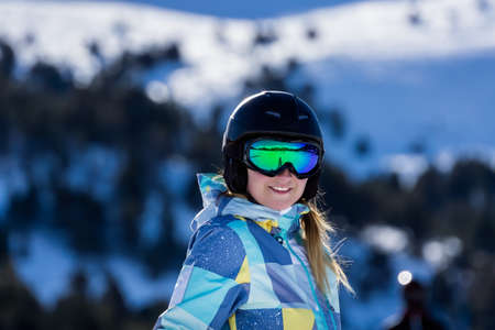 Portrait of smiling Caucasian white woman, skier with ski helmet and goggles. Winter holidays in El Tarter, Grandvalira, Andorraの写真素材