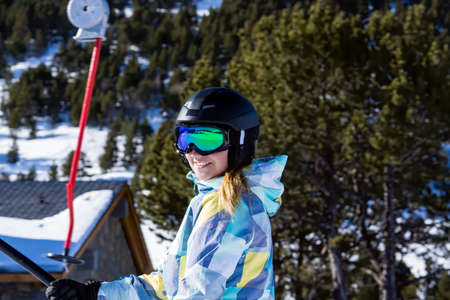 Selective focus on Caucasian white woman, skier riding up on draglift. Winter holidays in El Tarter, Grandvalira, Andorraの写真素材