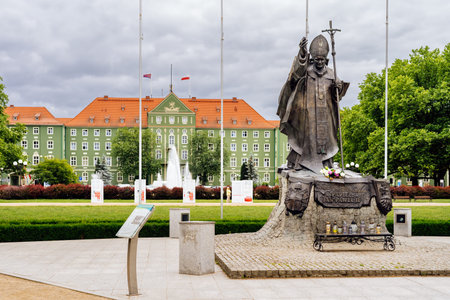 Szczecin, Poland, June 2018 Statue of Pope John Paul II on Jasne Blonia city park with green town hall and fountain in backgroundのeditorial素材