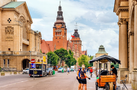 Szczecin, Poland, June 2018 People walking and relaxing on Rampart of Brave promenade with National...