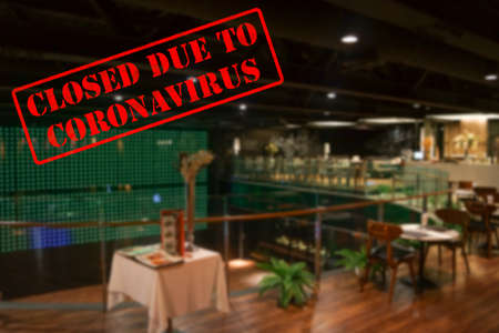 Defocused, blurred view of interior of an upmarket bar or restaurant, empty and closed due to coronavirus or covid 19 pandemicsの写真素材