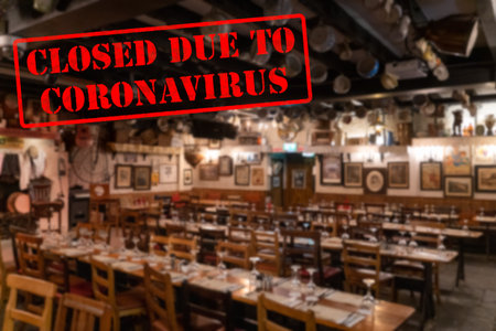 Defocused, blurred view of interior of traditional bar or restaurant, empty and closed due to...