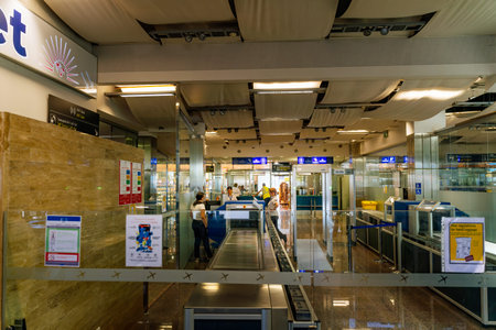 Zadar, Croatia, August 2019 Airport officers scanning passenger luggages with xrays and checking...