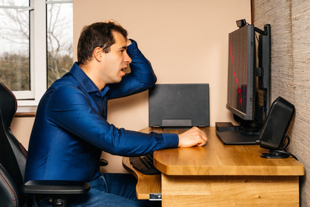 Middle age broken businessman in disbelief and shock, looking at stock market or his business as it...
