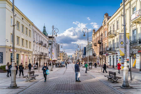 Kielce, Poland, March 2019 Busy promenade, Henryka Sienkiewicza street in Kielce with groups of people and tourists enjoying sunny walkのeditorial素材