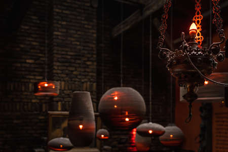 Aged grungy chandelier and lamps with dust and spider webs, light in darkness. Interior of abandoned manor or mansion. Halloween concept, backgroundの写真素材