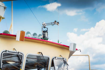 Two chrome ship sirens and set of loudspeakers on the top of the cabin. Closeup on nautical equipment, Szczecin, Polandの写真素材
