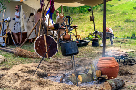 Cedynia, Poland, June 2019 Historical reenactment of Slavic or Vikings tribe tent camp with selective focus on camp fire, exhibiting peasants lifeのeditorial素材