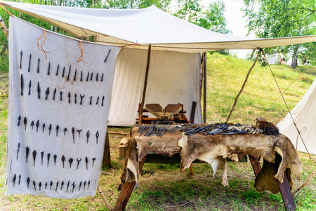 Bowyer, master craftsman workshop with variety of arrowheads and tools in historical reenactment of Slavic or Vikings tribe tent camp, Cedynia, Polandの写真素材