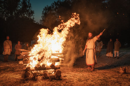 Cedynia, Poland, June 2019 Pagan reenactment of Kupala Night, called in Poland Noc Kupaly, shaman greeting strangers with knife at bonfire. Slavic holiday celebrated on the shortest night of the yearのeditorial素材