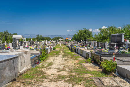 Graveyard next to Church of the Nativity of the Blessed Virgin Mary in Zaton with Dinaric Alps in a background, Croatiaのeditorial素材
