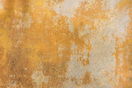 Old, grunge yellow cement, concrete or plaster wall with patterns and cracks. High quality texture...