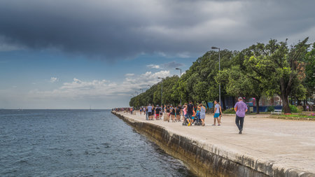 Zadar, Croatia, July 2019 Crowds of tourists walking and relaxing on the pier, Coast of King Petar...