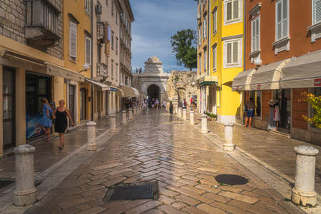 Zadar, Croatia, July 2019 Tourists visiting beautiful narrow streets of the old town district with polished marble cobblestone pavementのeditorial素材