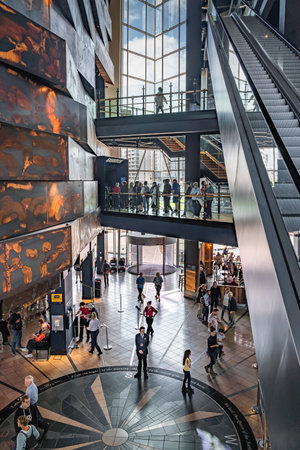 Belfast, UK, Aug 2019 Crowds of tourists visiting Titanic Museum. People queue to enter exhibition,...