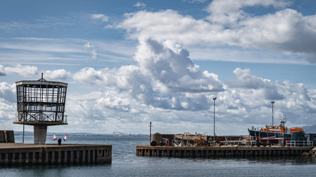 Entrance to Carrickfergus marina or port between two breakwaters. Boat maintenance in drydock,...